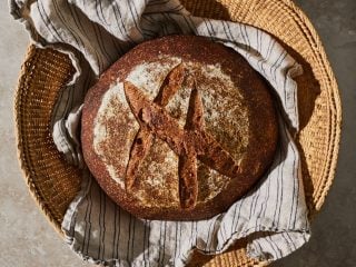 100% whole wheat sourdough bread in basket.