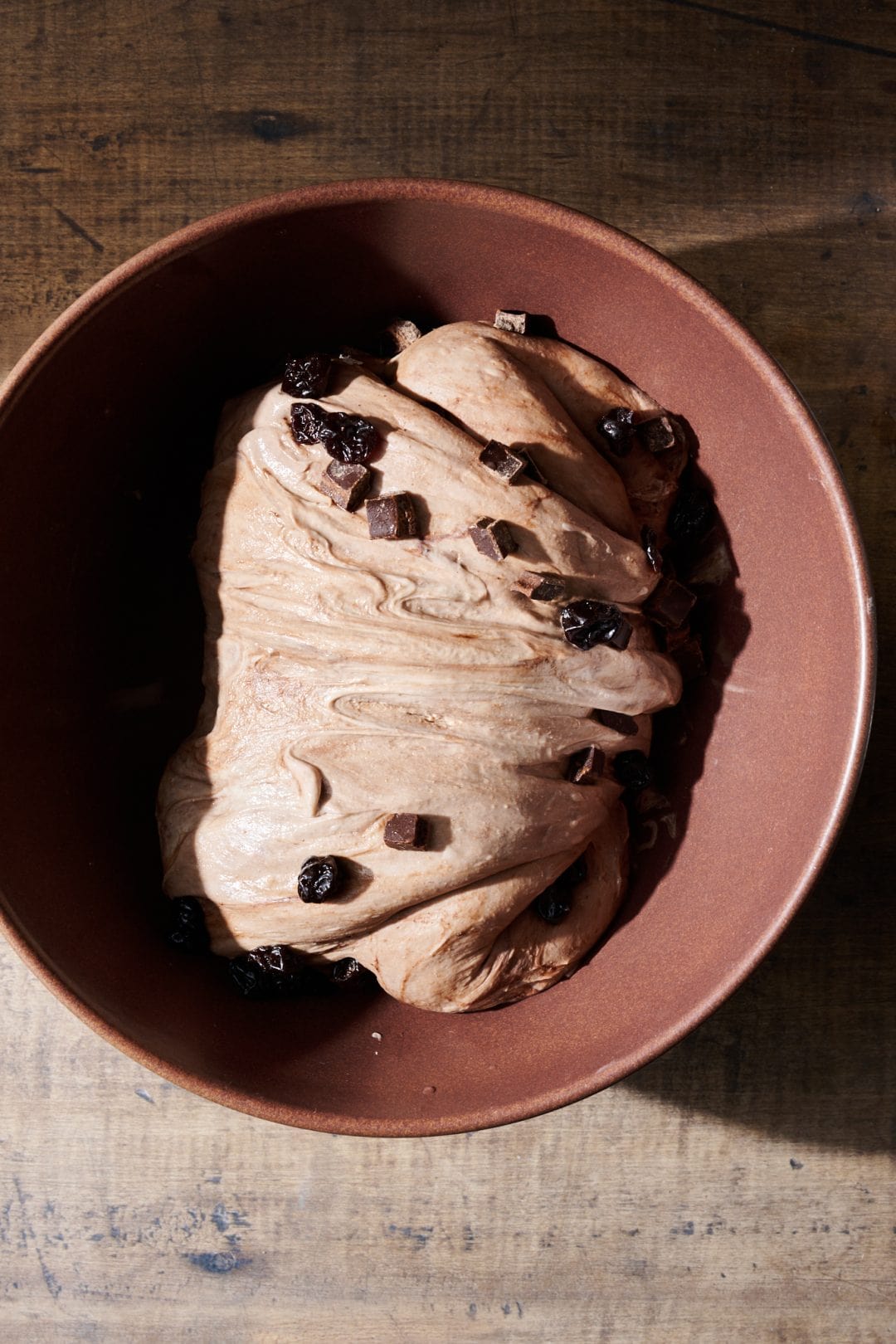 Adding chocolate and cherries to sourdough bread dough