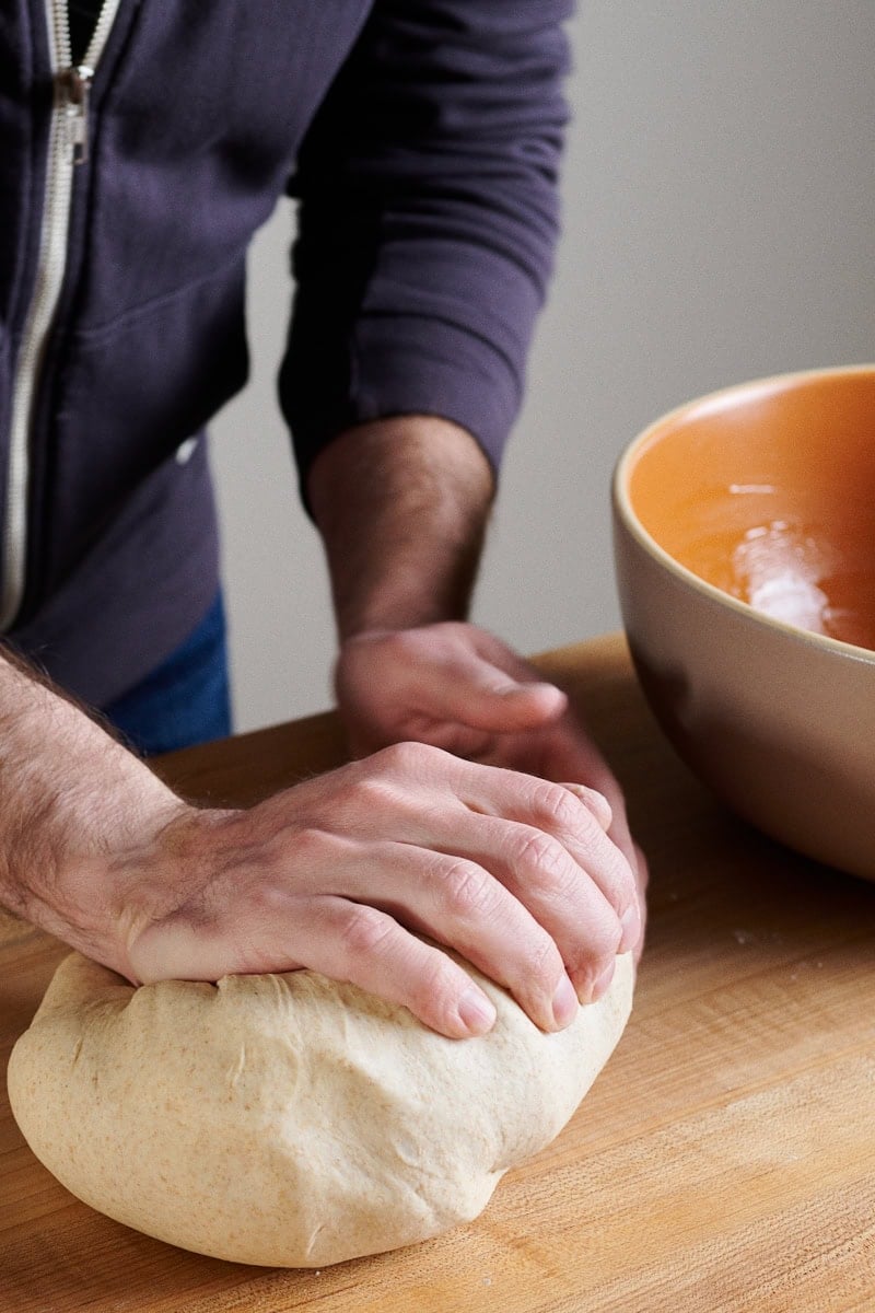 A photo of me mixing bread dough by hand.