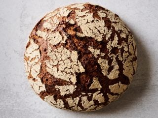 Sourdough 90-rye bread with cracked crust.