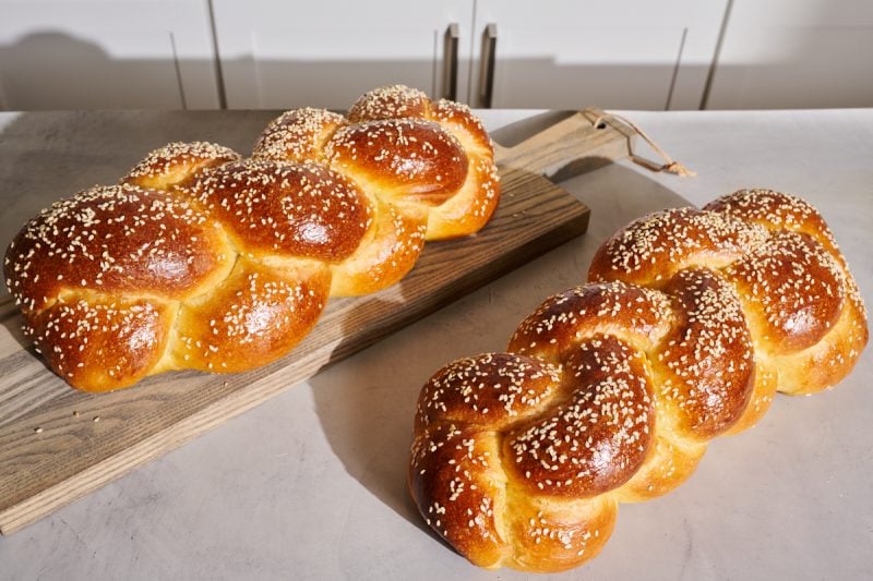 Braided sourdough challah on a table.