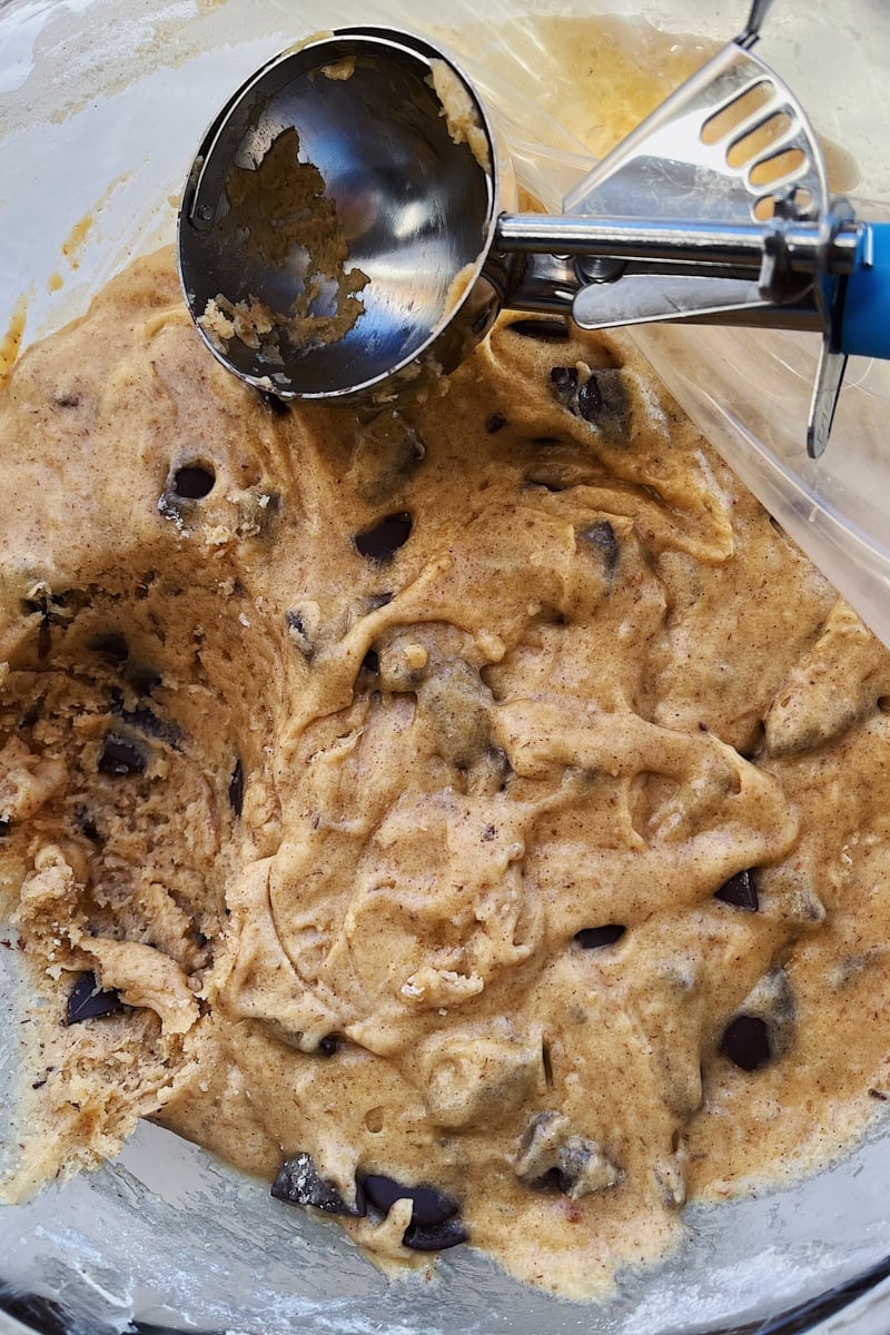 Scooping sourdough chocolate chip cookie dough before baking