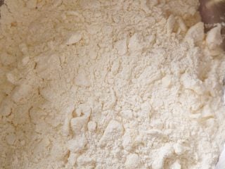 Working the butter into the flour for sourdough discard biscuits.